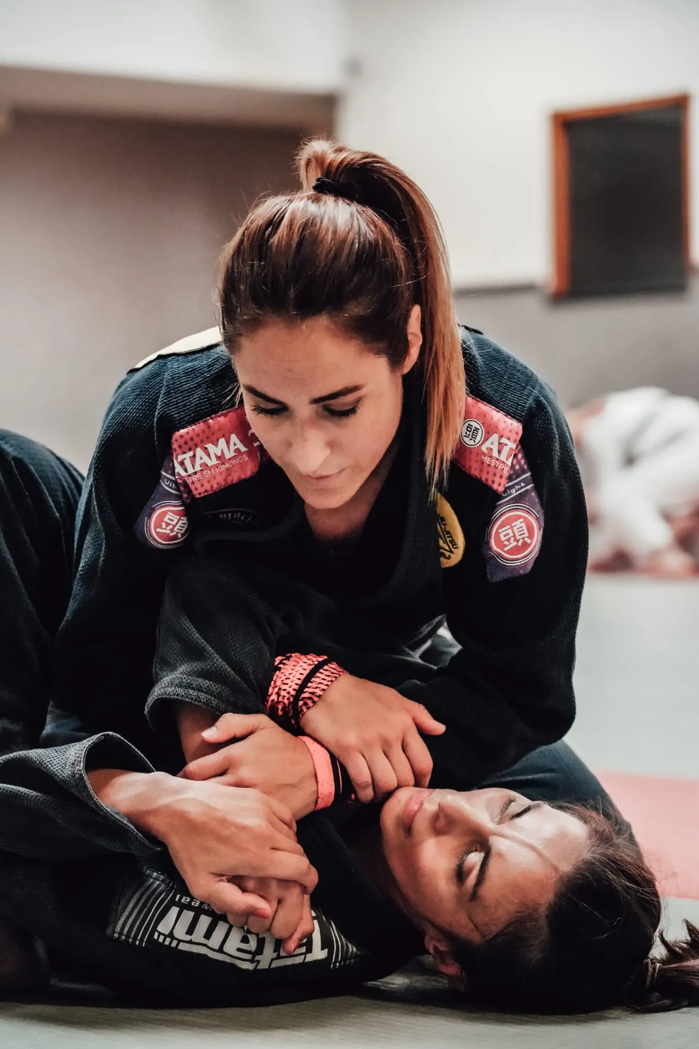 Amandine Layec en kimono noir, en contrôle au sol pendant un cours